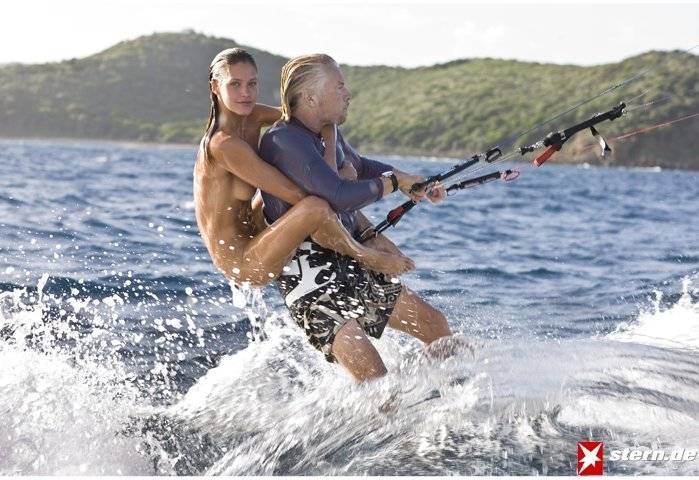 Richard Branson with naked model on his back