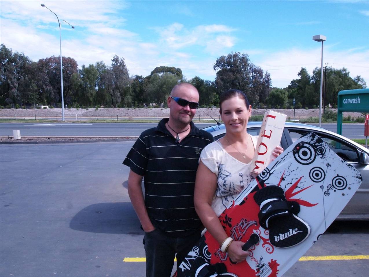 Brett and Belinda bringing the blade back and grabbing a bottle of Moet