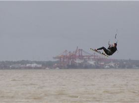 Ian - jumping the container terminal over a muddy bay