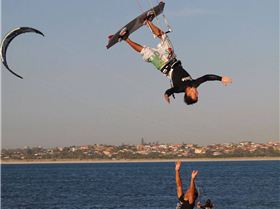Simon Deadman over dude on beach