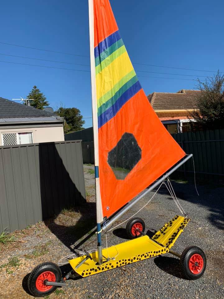 Mini with a deep and pointy Windsurfer sail with a bit chopped off the bottom