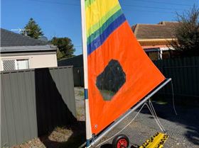 Mini with a deep and pointy Windsurfer sail with a bit chopped off the bottom