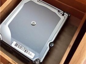 1165188866-old hard drive sitting in a dusty chest of drawers