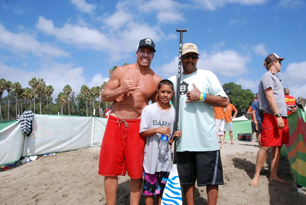 Riggs surfing his prone Bark board at the end of 10 mile race,  Riggs with Aaron and Chuck