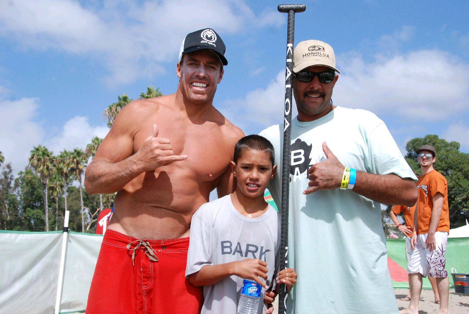 Riggs surfing his prone Bark board at the end of 10 mile race,  Riggs with Aaron and Chuck