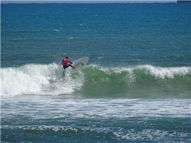Qld SUP surfing team members in action