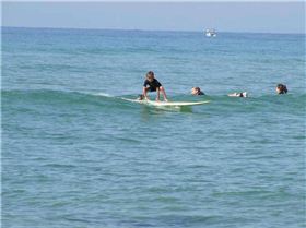 Ebony (6 years) Having a surf on her new glass board.