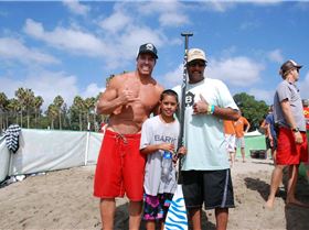 Riggs surfing his prone Bark board at the end of 10 mile race,  Riggs with Aaron and Chuck