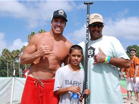 Riggs surfing his prone Bark board at the end of 10 mile race,  Riggs with Aaron and Chuck