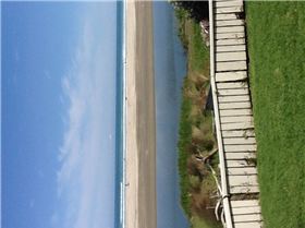 Slow flowing river out front of house.