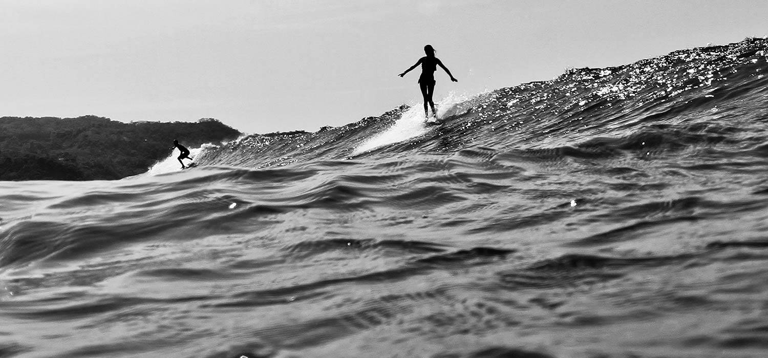 girl-longboarding-surfing-bw