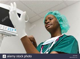 nurse-putting-on-latex-gloves-BTEHMN