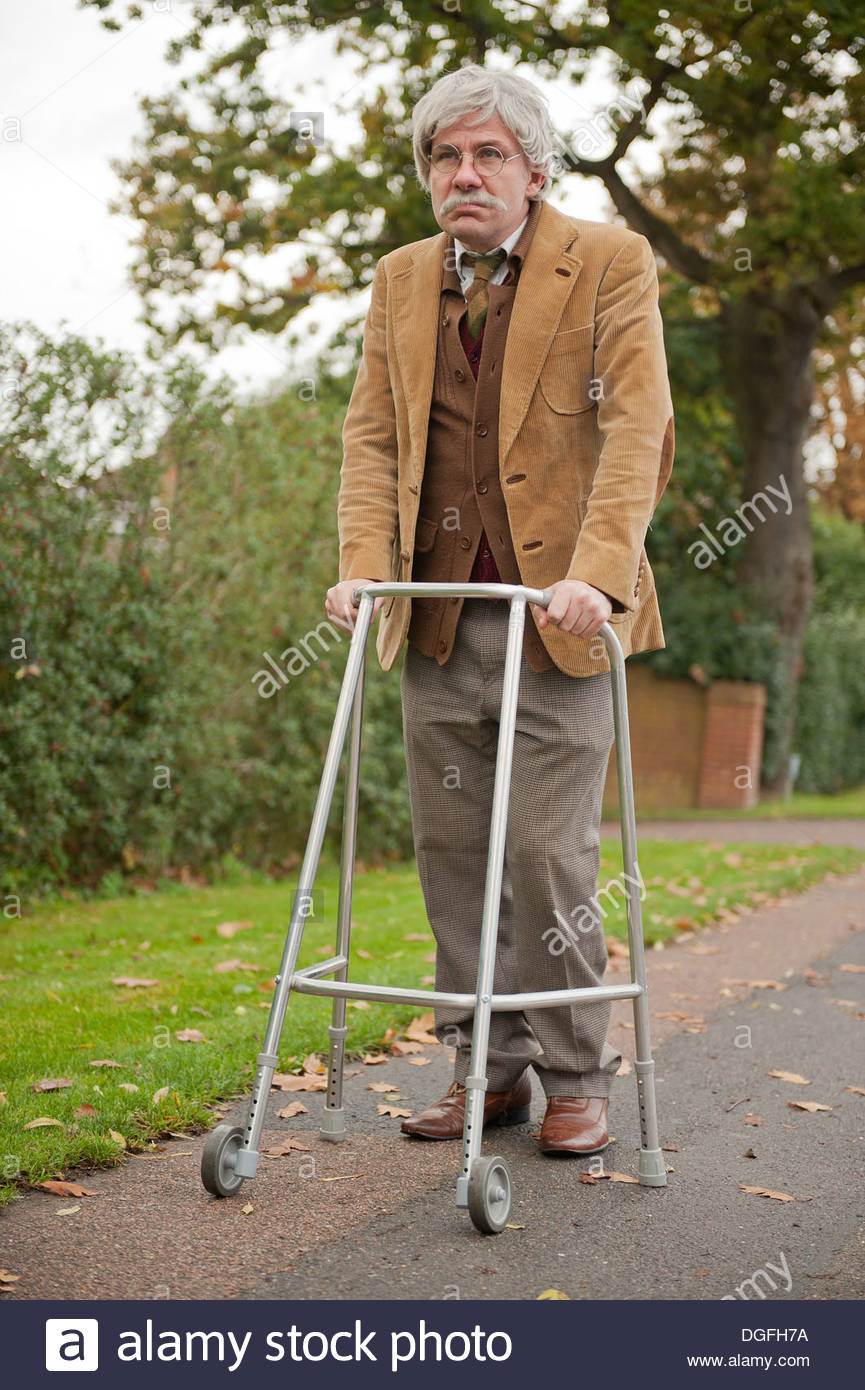 grey-haired-old-man-walking-along-with-his-zimmerframe-walking-aid-DGFH7A