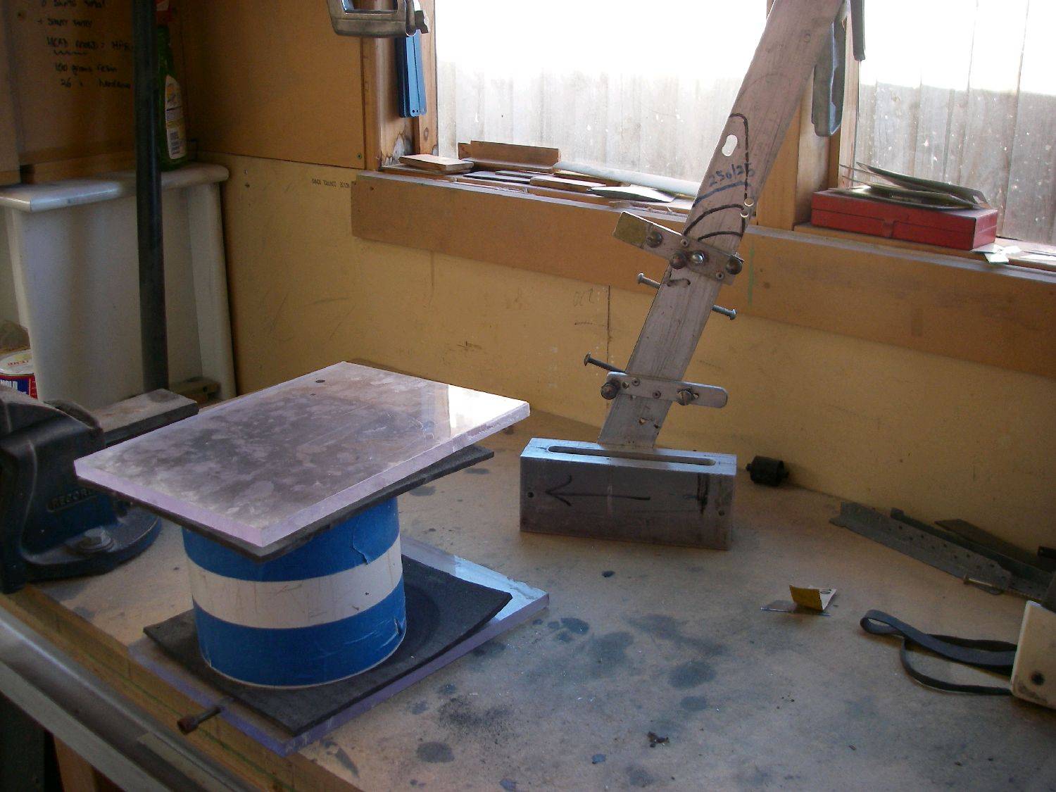 Vacuum tank for degassing resin, fin head mold in background