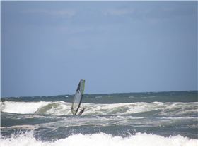 heading out in light onshore mush on a freestyle board