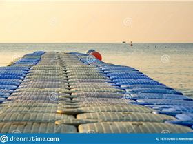 plastic-pontoon-sea-going-distance-swimming-background-lone-ship-out-focus-167120460